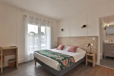 Un ou plusieurs lits dans un hébergement de l'établissement Hotel du Cap
