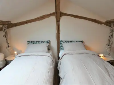 Un ou plusieurs lits dans un hébergement de l'établissement Les ecuries du chateau