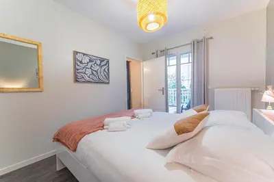 Un ou plusieurs lits dans un hébergement de l'établissement Chez Benjamin - Appt terrasse avec piscine commune