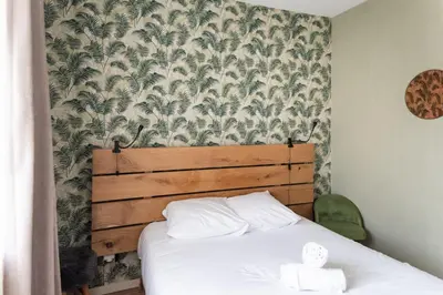 Un ou plusieurs lits dans un hébergement de l'établissement Maison chaleureuse 3* à deux pas de la plage