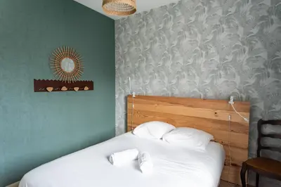 Un ou plusieurs lits dans un hébergement de l'établissement Maison chaleureuse 3* à deux pas de la plage