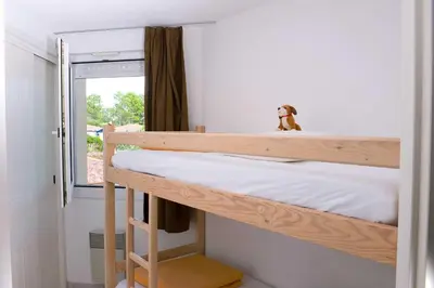 Un ou plusieurs lits dans un hébergement de l'établissement Madame Vacances Les Appartements de Moliets