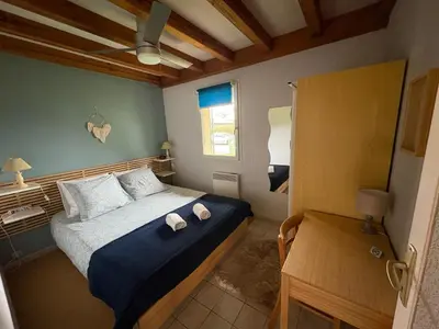 Un ou plusieurs lits dans un hébergement de l'établissement Maison de vacances à Cazaux
