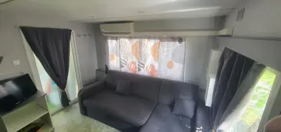 Télévision ou salle de divertissement dans l'établissement Mobile home Mimizan