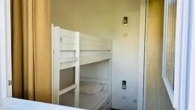 Un ou plusieurs lits dans un hébergement de l'établissement Les Cottages du Lac