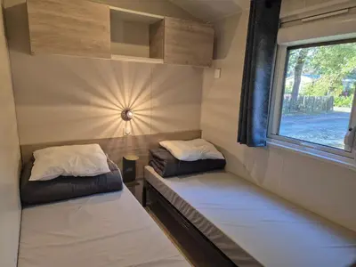 Un ou plusieurs lits dans un hébergement de l'établissement Cottage Les 2 Chardon