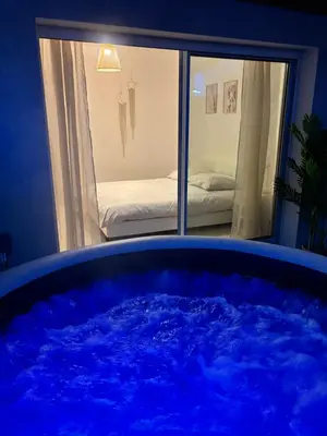 Un ou plusieurs lits dans un hébergement de l'établissement Cocon avec spa