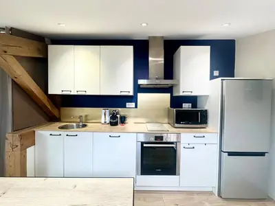 Cuisine ou kitchenette dans l'établissement Le Nid Douillet - Clim - Fibre - Chaleureux - Lumineux