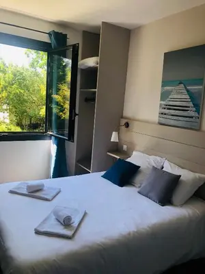 Un ou plusieurs lits dans un hébergement de l'établissement Hotel Cote et Lac