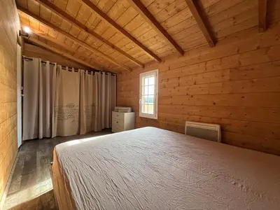 Un ou plusieurs lits dans un hébergement de l'établissement Le chalet du petit Laborde