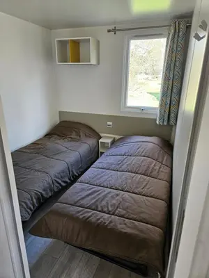 Un ou plusieurs lits dans un hébergement de l'établissement Camping familial les Chalets d'Uza