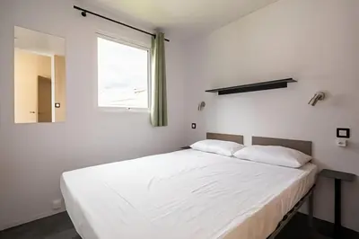 Un ou plusieurs lits dans un hébergement de l'établissement Camping Lou Pignada
