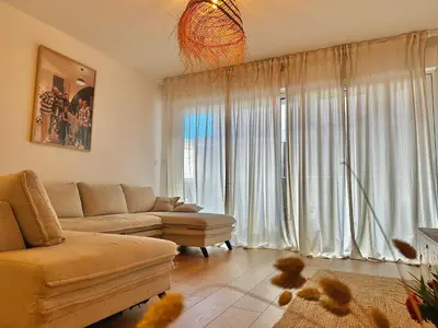 Coin salon dans l'établissement Appartement plage et lac