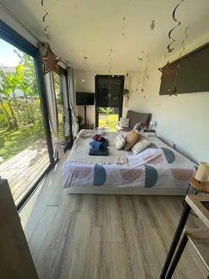 Un ou plusieurs lits dans un hébergement de l'établissement Chalet accueillant à Saint-Vincent-de-Tyrosse avec jardin