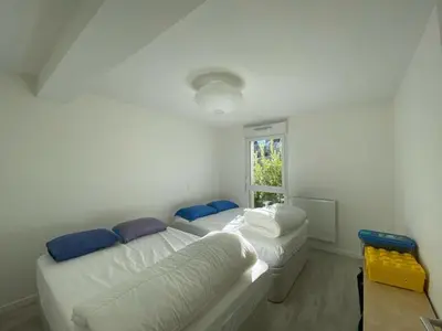 Un ou plusieurs lits dans un hébergement de l'établissement Appartement cosy proche centre Capbreton, situé dans un cadre boisé