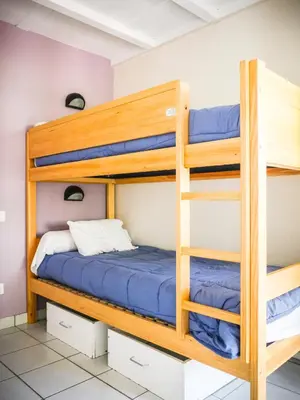 Un ou plusieurs lits dans un hébergement de l'établissement Village Vacances Les Genêts