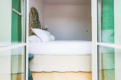 Un ou plusieurs lits dans un hébergement de l'établissement Hotel du Balcon