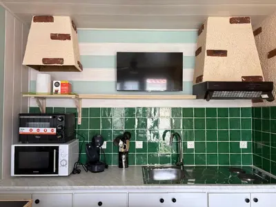 Cuisine ou kitchenette dans l'établissement Soleil et Sable