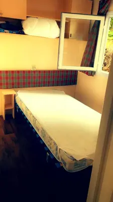 Un ou plusieurs lits dans un hébergement de l'établissement Mobile home location a la semaine