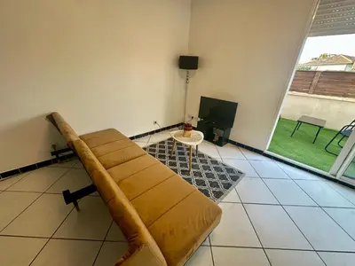 Coin salon dans l'établissement appartement cosy avec terrasse