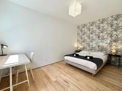Un ou plusieurs lits dans un hébergement de l'établissement Le Patio - Parking privé - Terrasse