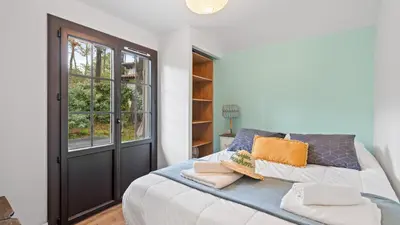 Un ou plusieurs lits dans un hébergement de l'établissement Maison de charme avec jardin et terrasse - Pyla