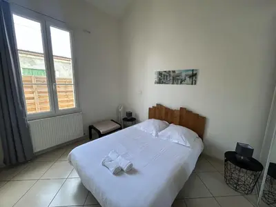Un ou plusieurs lits dans un hébergement de l'établissement Petite maison cœur de ville de La Teste de Buch