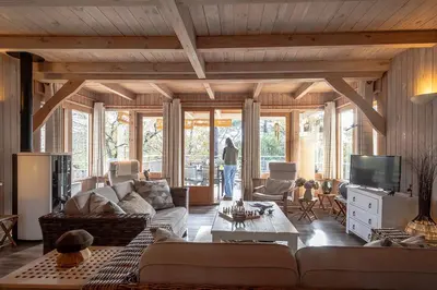 Télévision ou salle de divertissement dans l'établissement Ravissante villa tout bois avec piscine chauffée