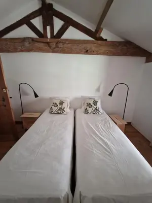 Un ou plusieurs lits dans un hébergement de l'établissement Les maisons de la baguette