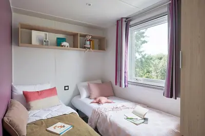 Un ou plusieurs lits dans un hébergement de l'établissement Camping le Laha