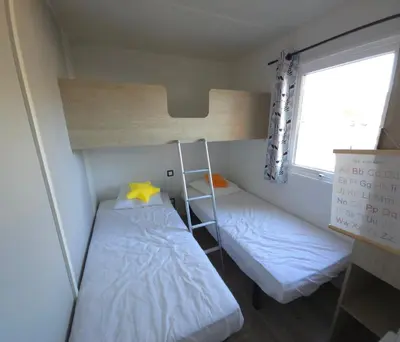 Un ou plusieurs lits dans un hébergement de l'établissement Mobilhome 5 PLACES