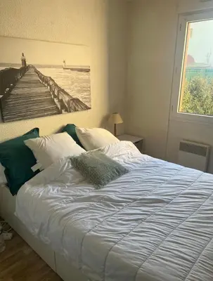 Un ou plusieurs lits dans un hébergement de l'établissement Grand appartement avec Terrasse entre la plage Sud et la Centrale