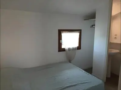 Un ou plusieurs lits dans un hébergement de l'établissement Maison 6 personnes avec jardin derrière la dune