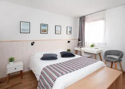 Un ou plusieurs lits dans un hébergement de l'établissement Hotel Atlantide