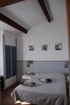 Un ou plusieurs lits dans un hébergement de l'établissement Hotel Atlantide