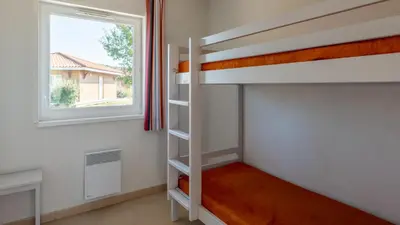Un ou plusieurs lits dans un hébergement de l'établissement Vacancéole - Le Domaine des Grands Lacs