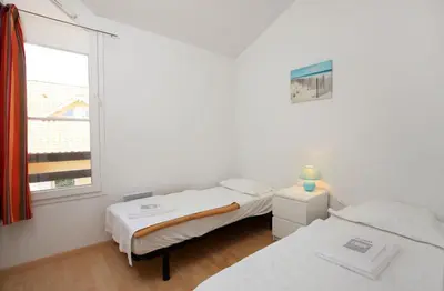 Un ou plusieurs lits dans un hébergement de l'établissement Résidence Belle Dune Blanche, maisons et appartements