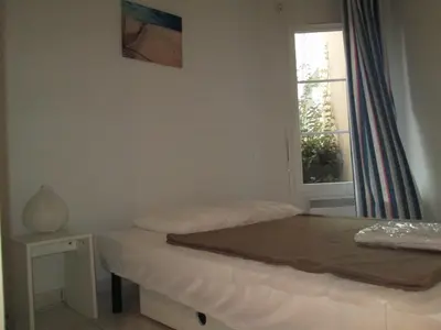 Un ou plusieurs lits dans un hébergement de l'établissement Résidence Belle Dune Blanche, maisons et appartements