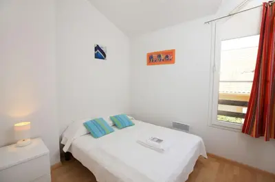Un ou plusieurs lits dans un hébergement de l'établissement Résidence Belle Dune Blanche, maisons et appartements