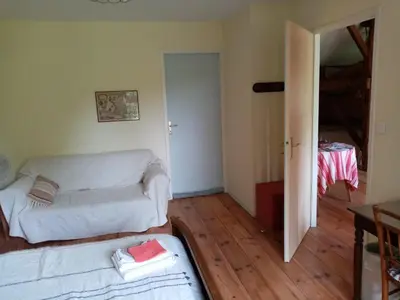 Un ou plusieurs lits dans un hébergement de l'établissement Ricouch, chambre d'hôtes et permaculture