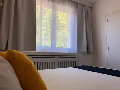Un ou plusieurs lits dans un hébergement de l'établissement Hôtel du Lac d'Arjuzanx