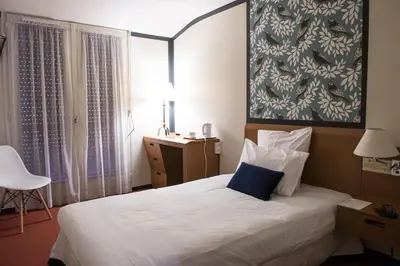 Un ou plusieurs lits dans un hébergement de l'établissement Hotel de Jouvence