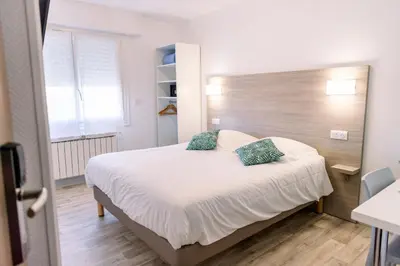 Un ou plusieurs lits dans un hébergement de l'établissement Hotel Atlantique