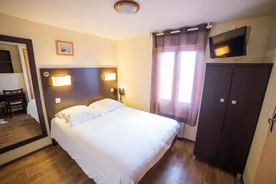 Un ou plusieurs lits dans un hébergement de l'établissement Hotel Atlantique