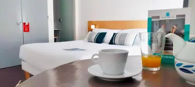 Un ou plusieurs lits dans un hébergement de l'établissement Hotel Thermes Les Ecureuils-Dax