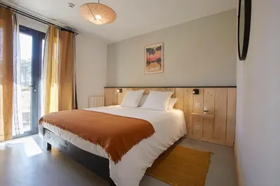 Un ou plusieurs lits dans un hébergement de l'établissement HOTEL COTE PHARE