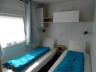Un ou plusieurs lits dans un hébergement de l'établissement Escape MobilHome aux Dunes de Contis