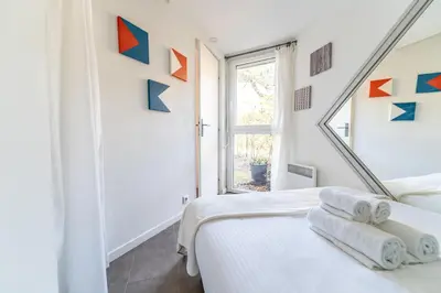 Un ou plusieurs lits dans un hébergement de l'établissement L'Orée - Appartement cosy face aux pins