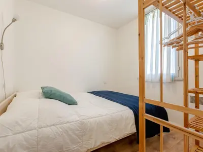 Un ou plusieurs lits dans un hébergement de l'établissement Apartment Les Bourdaines by Interhome