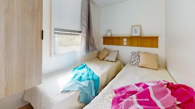 Un ou plusieurs lits dans un hébergement de l'établissement Camping Officiel Siblu Le Pipiou